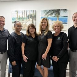 Dunedin Dental Associates team of dentists and dental staff smiling together at their Dunedin, FL dental office